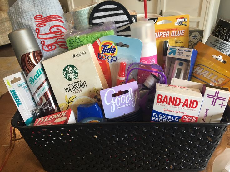 a black basket filled with lots of different types of items on top of a table