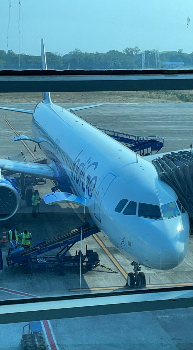 an airplane sitting on the tarmac at an airport