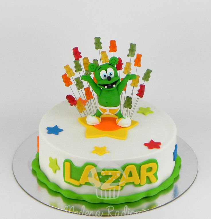 a birthday cake decorated with an image of a green frog on top of it and the words lazar written in large letters