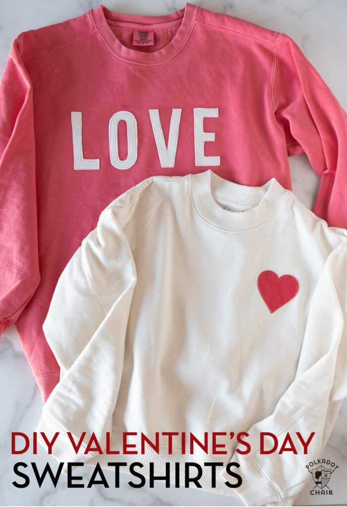 two valentine's day sweatshirts with the words love and heart on them, sitting next to each other