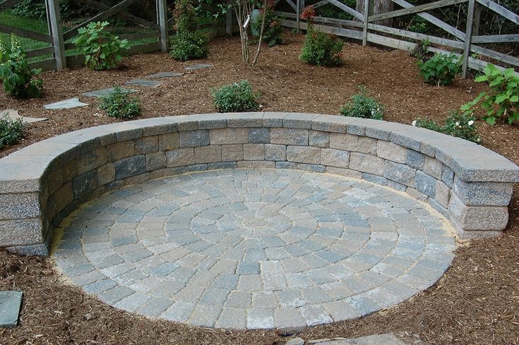 a stone bench sitting in the middle of a garden