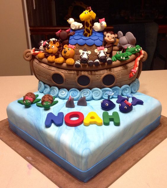 a birthday cake decorated with noah's ark and animals on the top is for noah