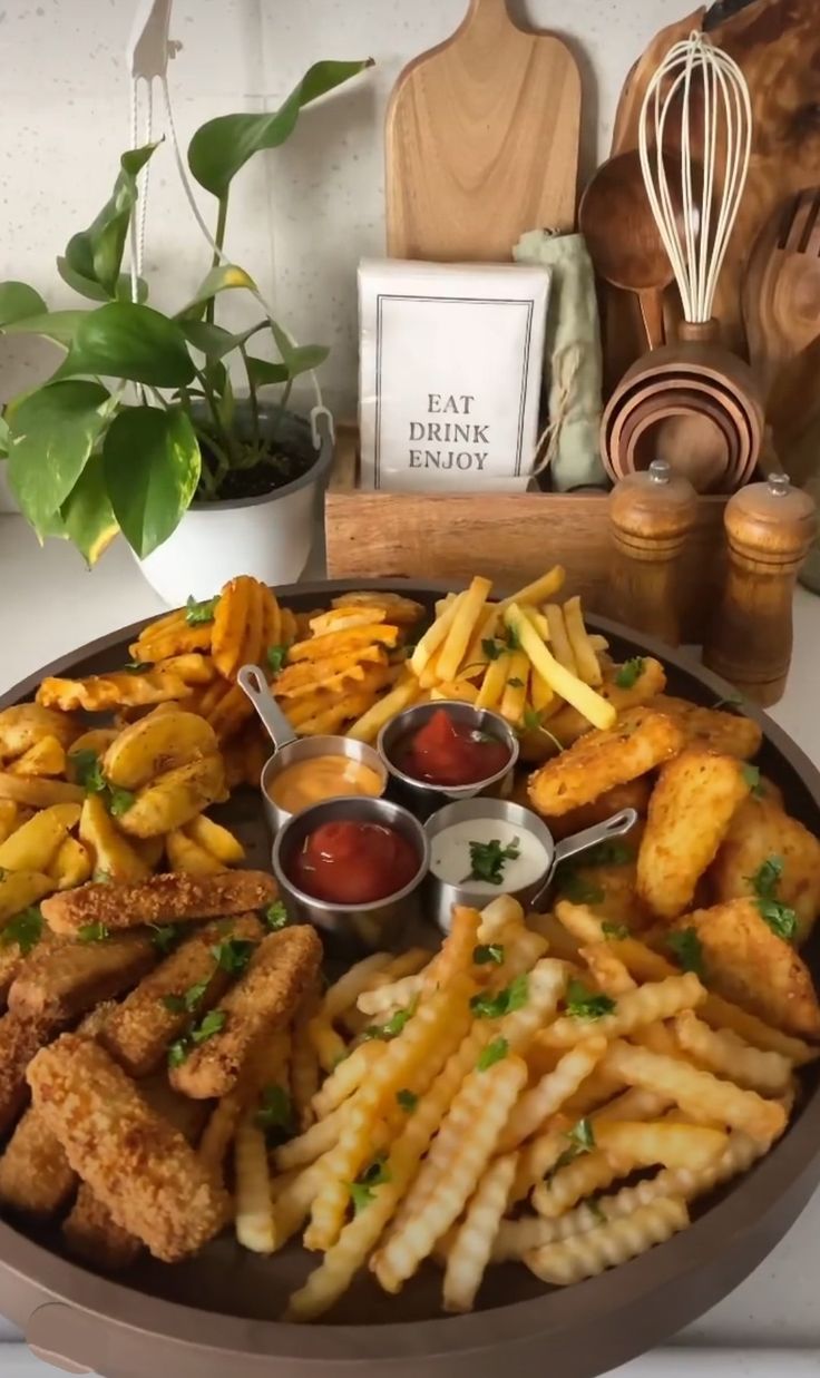 a platter filled with french fries and ketchup on top of a table