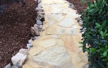 a stone path in the middle of a garden