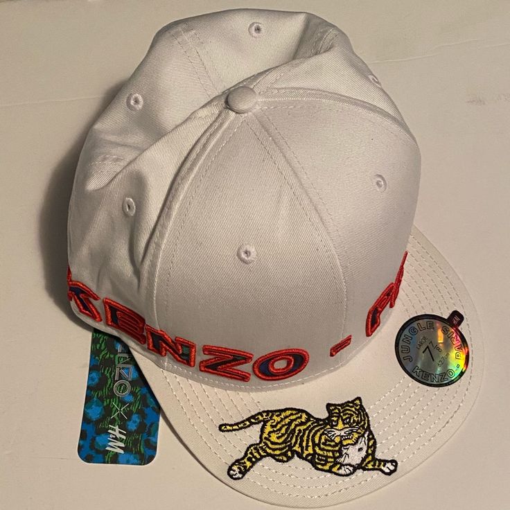 Brand New With Tags Kenzo X H&M Baseball Cap. Never Been Worn. Limited Edition Part Of The Sold Out Collaboration. According To The Tag This Is A Size Large. Designer White Snapback Hat, Designer Baseball Cap For Streetwear, Designer White Visor Baseball Cap, Designer Streetwear Cap, Designer White Visor Hat, Designer White Flat Brim Hat, Designer White Hats For Spring, Designer White Spring Hat, Designer Visor Hats For Spring