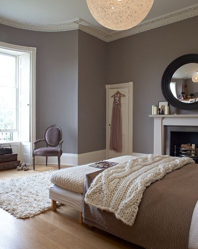 a bedroom with a bed, mirror and fireplace in it's centerpieces