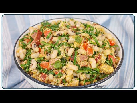 a bowl filled with lots of food on top of a blue and white table cloth