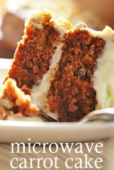 a slice of carrot cake on a white plate with a fork in front of it