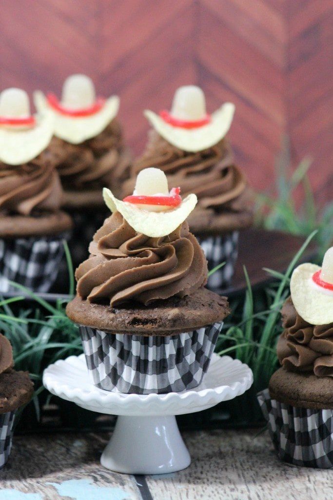 cupcakes with chocolate frosting and apples on top