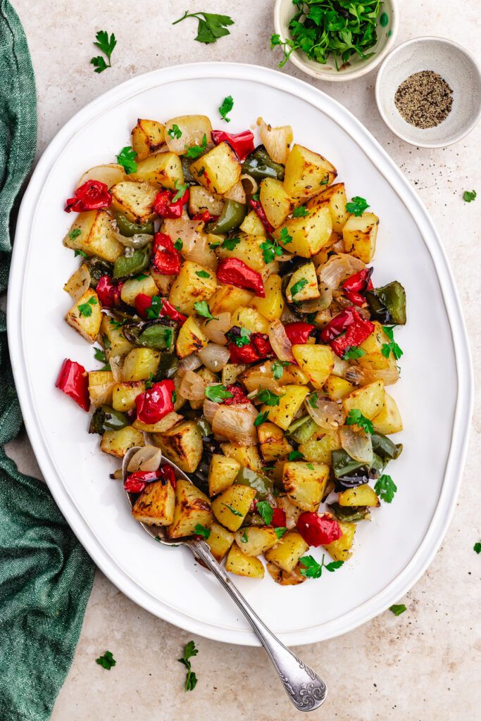 a white plate topped with potatoes and peppers