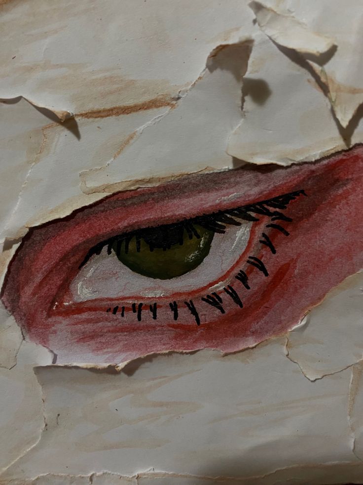 an eye is shown through the torn paper