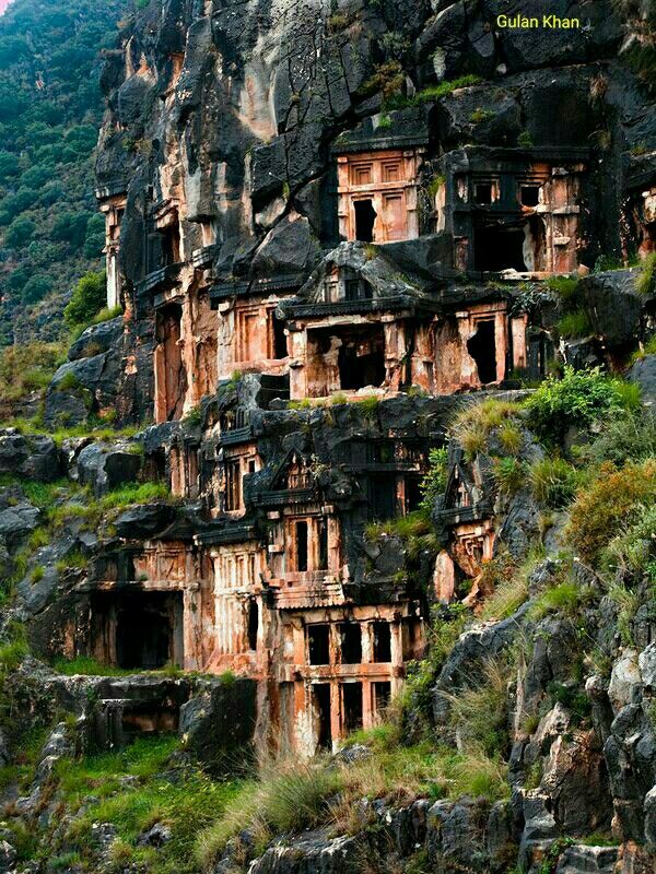 some very old buildings on the side of a mountain