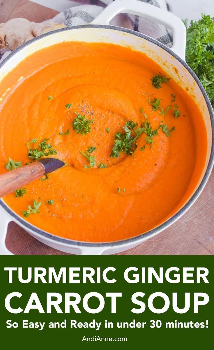 a bowl filled with carrot soup and garnished with parsley on the side