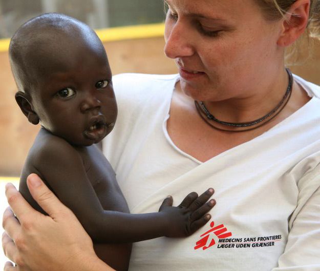 a woman holding a baby in her arms