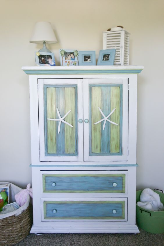 a white and blue cabinet with starfish decorations on it