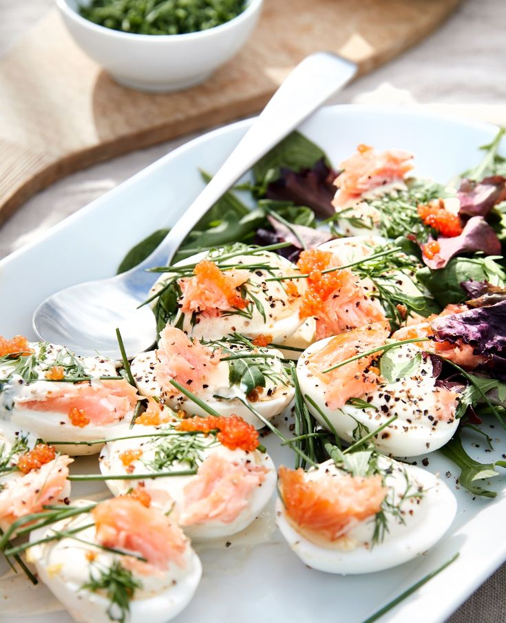 a white plate topped with hard boiled eggs and salad