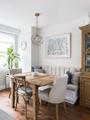 a dining room table with chairs and a bench