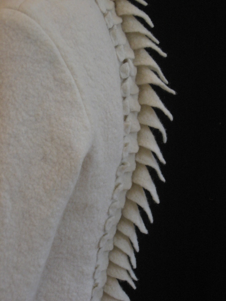 a close up of a white towel with spikes on it's back and sides