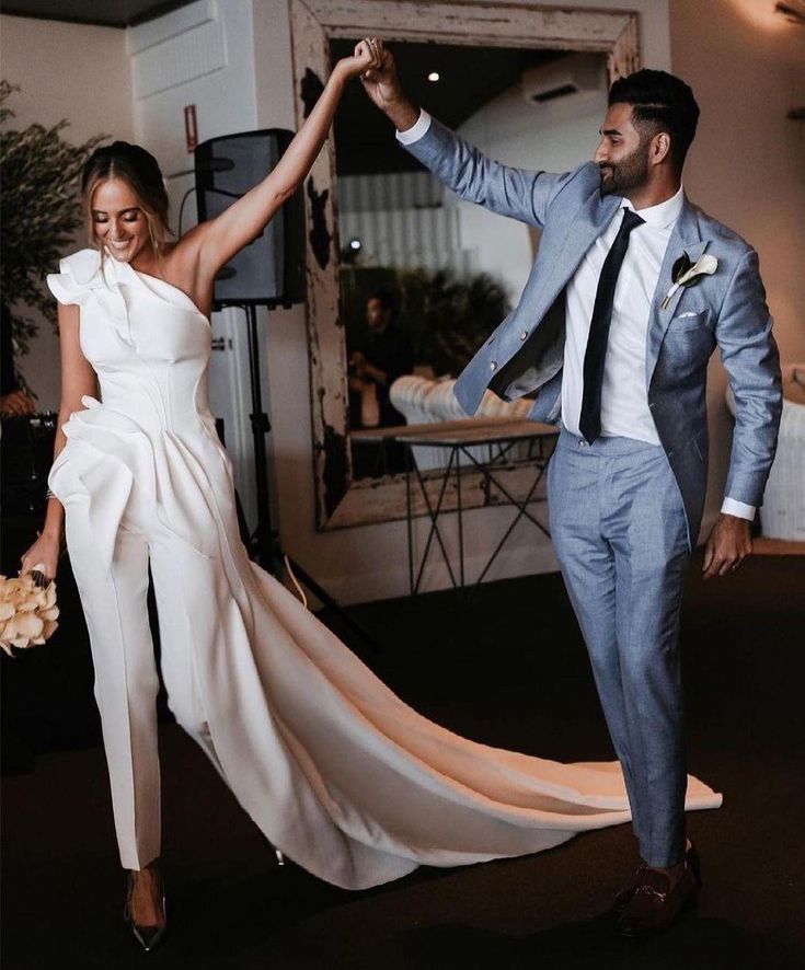 a bride and groom dancing together at their wedding reception