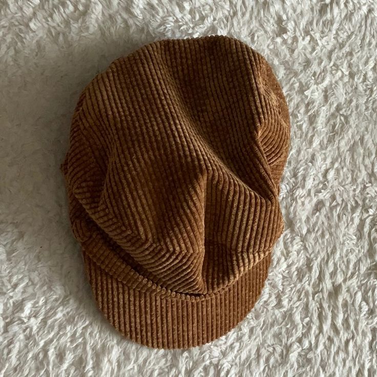 a brown hat laying on top of a white carpet