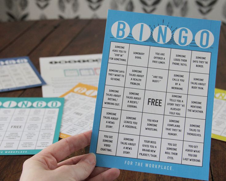 a hand holding up a blue and white printable game for the monopoly boardgame