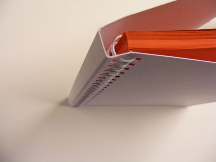 an orange folder sitting on top of a white table