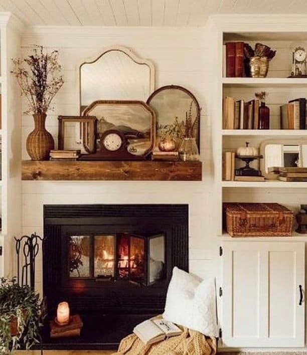 a living room filled with furniture and a fire place next to a bookshelf