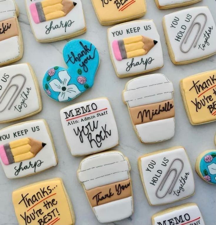 some cookies with writing on them and pencils in the shape of thank you notes