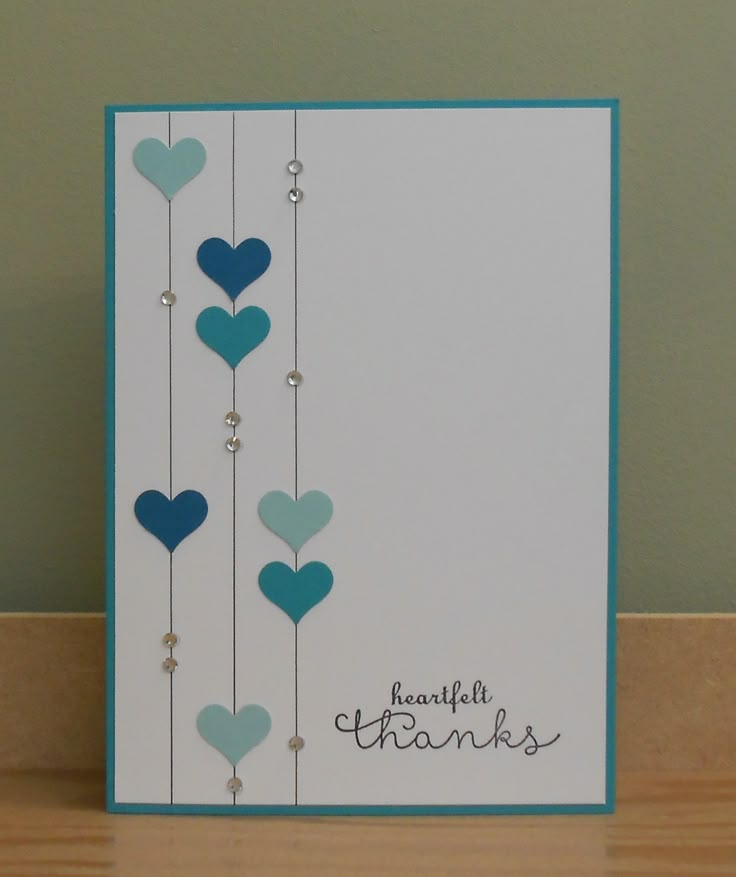 a card with blue hearts hanging from strings