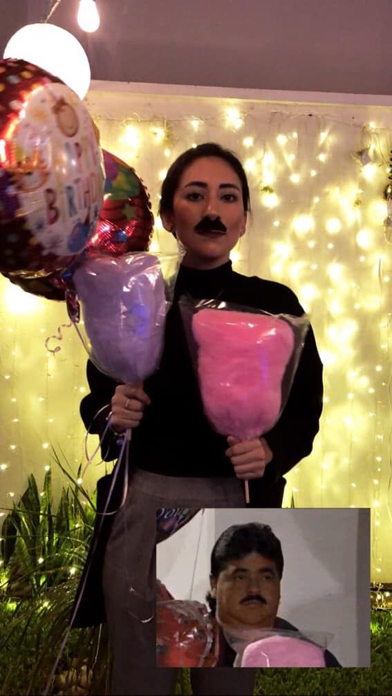 a woman holding some balloons and a man with a moustache on his face