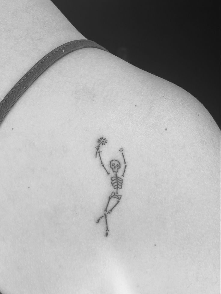 Tiny skeleton tattoo with a flower in its hand Cute Small Skeleton Tattoos, Skeleton Small Tattoo, Tiny Skeleton Tattoo Simple, Skeleton Tattoo Minimalist, Skeleton Friend Tattoo, Aesthetic Small Tattoo Ideas, Human Outline Tattoo, Skeleton With Headphones Tattoo, Skeleton Minimalist Tattoo