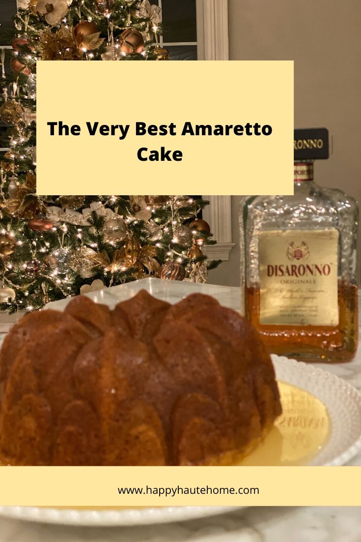 a bundt cake sitting on top of a white plate next to a christmas tree