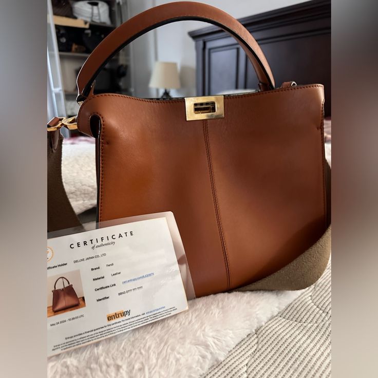 This Stylish Handbag Is Crafted Of Soft Nappa Lambskin Leather In Brown. It Features A Leather Top Handle, An Optional Crossbody Strap, And Gold Fendi Logo Turn Locks. Provided With Entrupy Certificate For Authenticity. Fendi Logo, Fendi Bags, Leather Top, Lambskin Leather, Fendi, Bag Lady, Handbags, Shoulder Bag, ? Logo