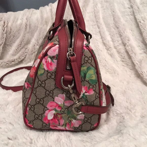 Gucci top handle bag/crossbody GG Blooms top handle Boston bag with crossbody strap 11”w x 7”h x6”d Interior brown suede and leather detailing Hardware is silver 5 silver metal feet Almost brand new Gucci Bags Mini Bags Gucci Multicolor Tote Bag, Gucci Satchel With Detachable Strap, Designer Gucci Satchel With Detachable Handle, Gucci Pink Shoulder Bag With Detachable Handle, Pink Gucci Bag With Detachable Handle, Gucci Multicolor Shoulder Bag For Daily Use, Gucci Top Handle Satchel, Gucci Designer Satchel With Detachable Strap, Designer Gucci Satchel With Detachable Strap