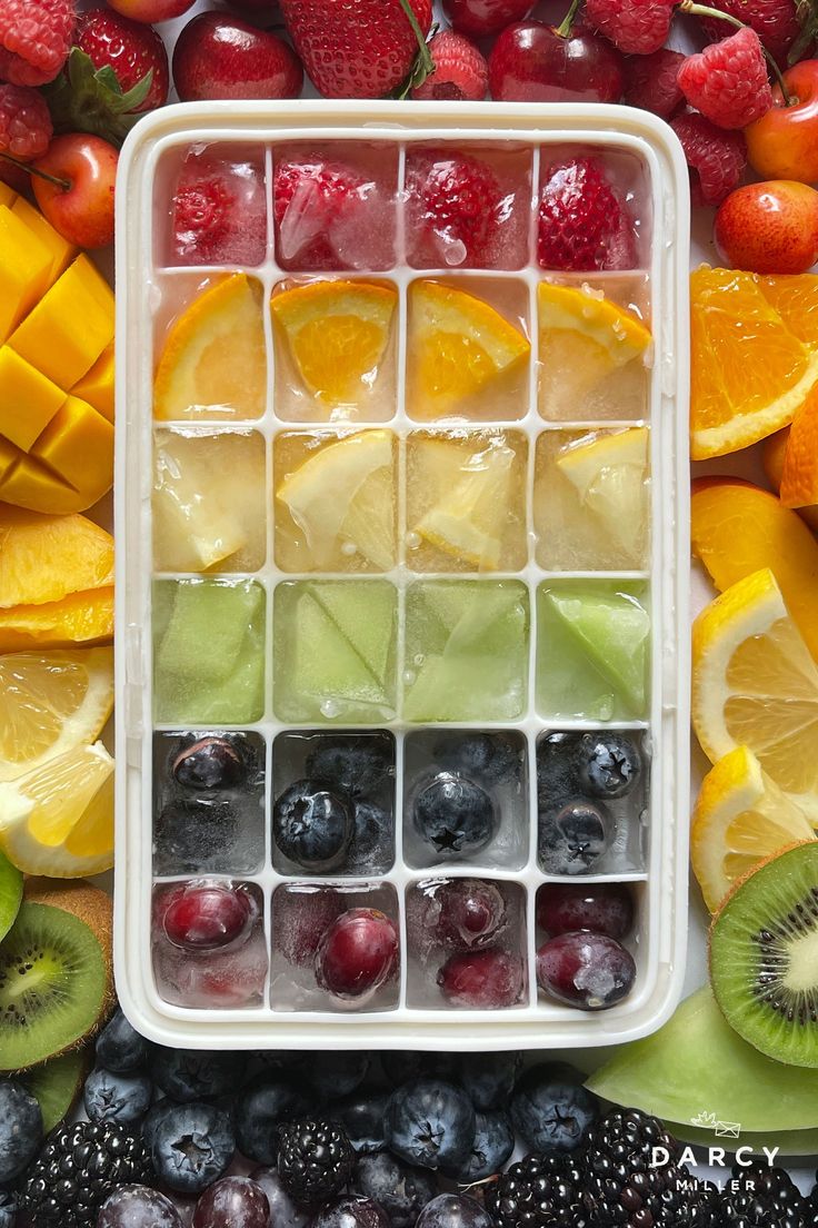 fresh fruits are arranged in an ice cube tray