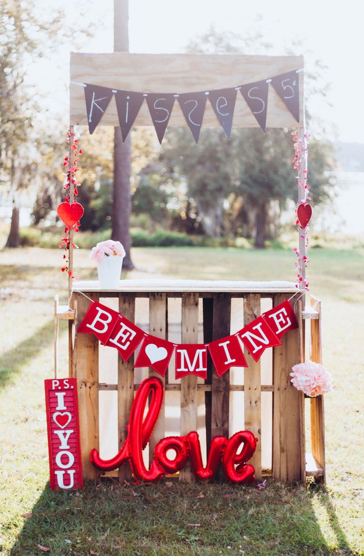 a sign that says be my love hanging from the side of a wooden crate with red letters