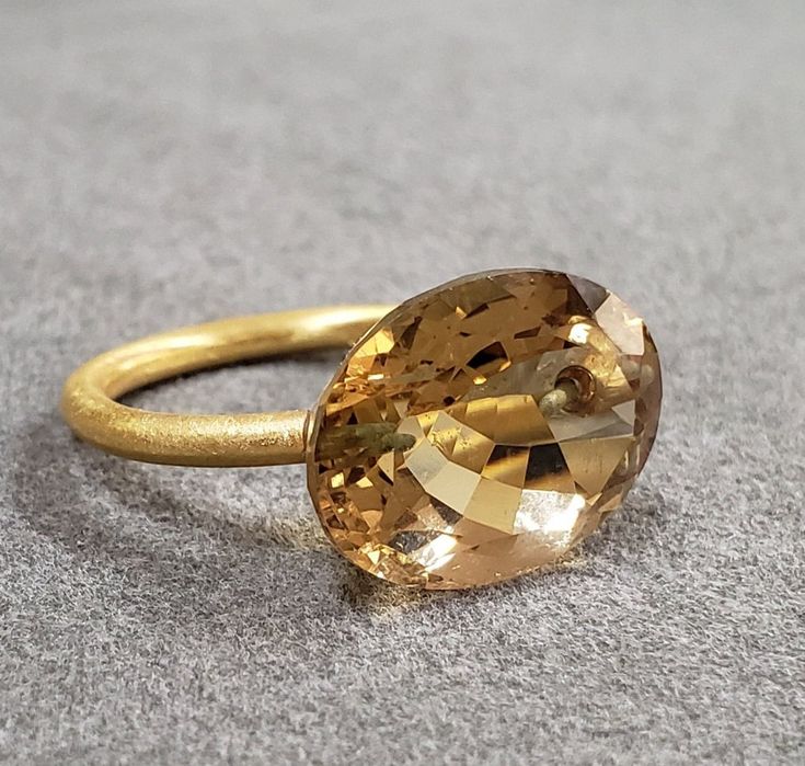 1. Drilled 14k Gold Champagne Quartz Ring 2. Resizable 3. Gemstone - Champagne Quartz 4. Jewelry Type - Gold Ring 5. Total weight - 4.160 Gram Approx.  6. Quartz Weight - 9.20 Carats  7. Gold Weight - 2.320 Grams Approx.  8. Quartz Size - 12x16 MM 9. Gold Purity - 14k 10. Handmade Items 11. Band Size - 2 MM 12. Oval Shape 13. AAA Quality 14. Half Drilled  15. 1 Quantity Available 16. Ready to Dispatch in 1 - 2 days.  Pictures are taken under natural and day light. Luxury Oval Yellow Gold Topaz Ring, Luxury Yellow Gold Oval Topaz Ring, Oval Faceted Rings In Fine Jewelry Style, Timeless Oval Faceted Jewelry, Gold Oval Faceted Ring, Luxury Oval Faceted Topaz Ring, Gold Oval Topaz Ring For Anniversary, Oval Gold Faceted Rings, Modern 14k Gold Oval Topaz Ring