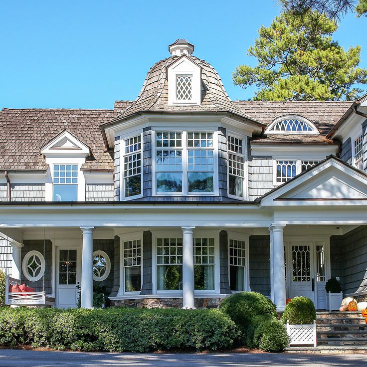 a large house with white trim and windows