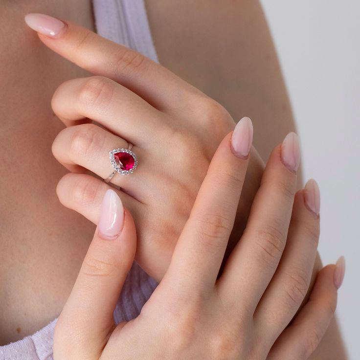 A truly unique ring for the woman who loves to stand out from the crowd. This 10K or 14K or 18K gold ring is shaped like a pear, but with a large tear drop ruby stone in the center. The gold band wraps around the stone, creating a beautiful contrast between the two colors. This makes it a great choice for those who want something simple and classic without being boring or dull. It's also ideal if you're looking for something that is both elegant and eye-catching at the same time!    This ring would make a perfect engagement ring or promise ring because it features an impressive gemstone that will always be remembered as being part of your special day together. It can also be worn on its own as an everyday piece of jewelry thanks to its sleek design and comfortable fit!    You can choose th Pear-shaped Promise Rings For Valentine's Day, Valentine's Day Pear-shaped Fine Jewelry Rings, Valentine's Day Pear-shaped Fine Rings, Red Diamond Princess Cut Ring, Red Princess Cut Diamond Ring, Red Cluster Ring With Brilliant Cut For Promise, Red Brilliant Cut Cluster Ring For Promise, Ruby Rings With Center Stone For Proposal, Princess Cut Rings With Accent Stones For Proposal