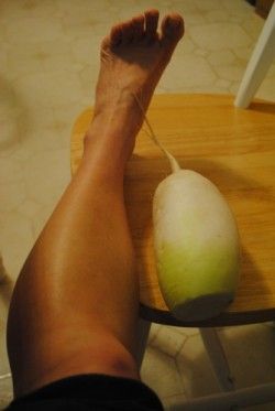 a person sitting on a chair with their feet propped up next to an onion peel