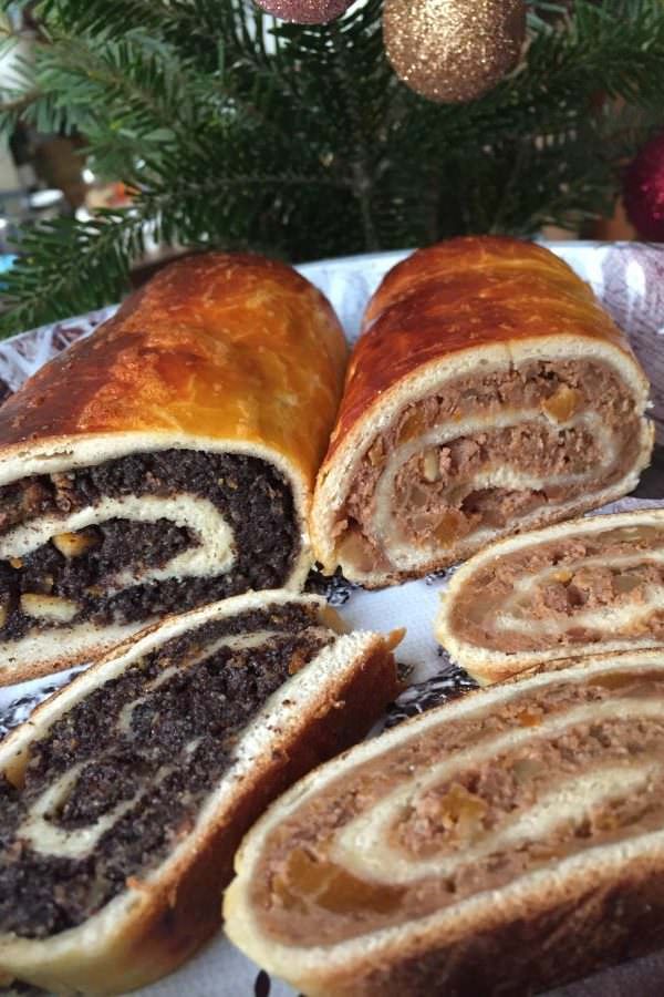 there is a large roll on the plate with other pastries in front of it