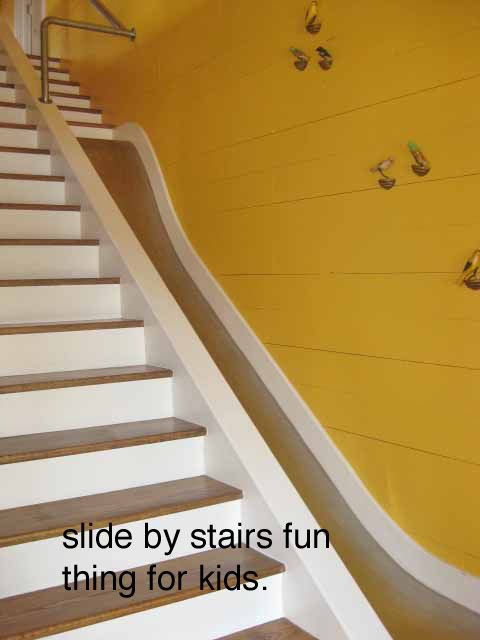 there is a stair case next to a wall with skateboards on it and the words slide by stairs fun thing for kids