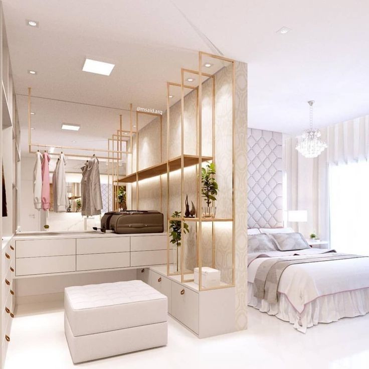 an image of a bedroom setting with white furniture and gold accents on the walls,