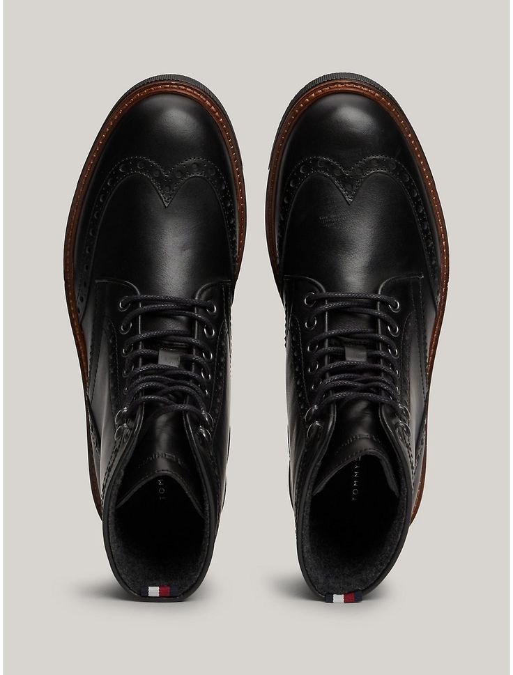 Tommy Hilfiger men's boot. Traditional brogue detailing lends a stylish touch to these lace-up boots, while warm linings and water-repellent leather make them ideal for tran-seasonal wear.  Material: 100% Leather (fwa). Casual Wingtip Lace-up Boots With Rubber Sole, Formal Wingtip Lace-up Boots For Winter, Winter Formal Lace-up Boots With Brogue Detailing, Goodyear Welted Lace-up Boots For Business In Winter, Business Lace-up Boots With Goodyear Welt For Winter, Winter Business Lace-up Boots With Goodyear Welt, Classic Wingtip Lace-up Boots For Winter, Winter Business Lace-up Boots With Brogue Detailing, Winter Cap Toe Lace-up Boots With Brogue Detailing