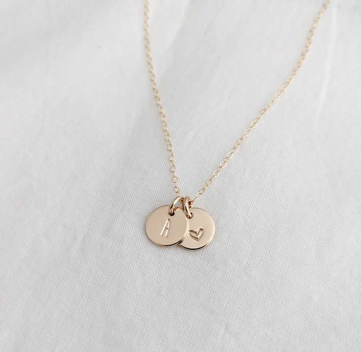 Each tiny charm measures 3/8" (9.5mm). One is personalized with a tiny heart design, the other, an initial of your choice. Available in solid .925 sterling silver or 14k gold fill. Material and chain length can be made from the drop down menu. Please leave me a note in the personalization box with the initial you would like. Dainty Charm Necklace With Heart Charm And Round Pendant, Everyday Tiny Initial Pendant Charm Necklace, Everyday Initial Pendant Necklace With Heart Charm, Personalized Sterling Silver Initial Necklace With Heart Charm, Personalized Minimalist Sterling Silver Charms, Minimalist Personalized Sterling Silver Charms, Small Personalized Charm Necklaces For Everyday, Dainty Personalized Round Pendant Heart Necklace, Personalized Small Charm Necklaces For Everyday