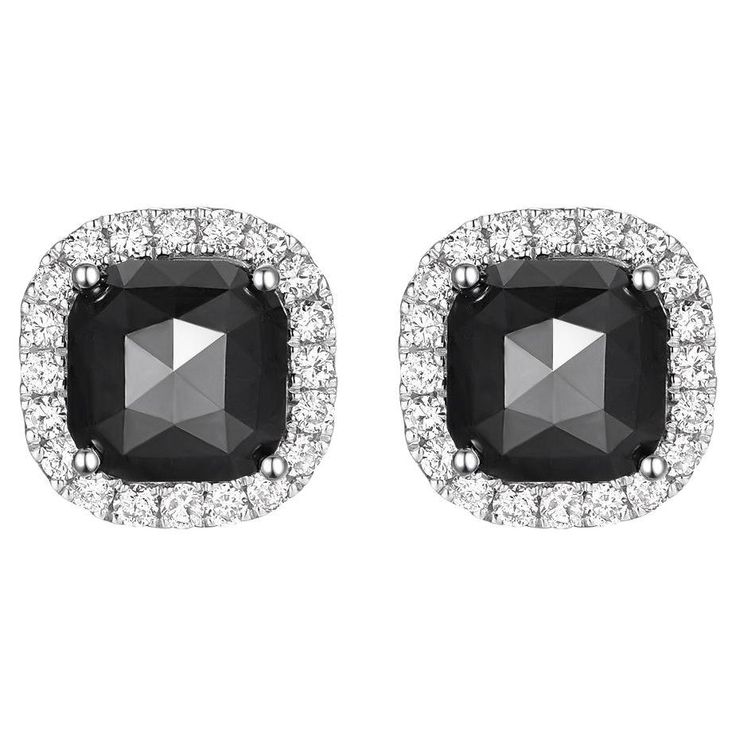 These exquisite stud earrings showcase the unique allure of rose-cut black diamonds, each weighing 1.83 carats, set in a luxurious 14K white gold. The central black diamonds exude a sophisticated charm, their multifaceted rose cut enhancing the stones' deep, enigmatic sparkle. Encircling each black diamond is a halo of glittering white round diamonds, adding an additional 0.24 carats to the piece. The contrast between the bold darkness of the black diamonds and the bright shimmer of the white di Luxury Timeless Halo Diamond Earrings, Luxury Elegant Black Diamond Earrings, Luxury Silver Diamond Earrings With Black Diamonds, Luxury White Gold Earrings With Black Diamonds, Luxury Black Diamond Drop Earrings, Classic Black Diamond-cut Earrings, Black Diamond Earrings Studs, Black Diamond Studs, Black Diamond Earrings