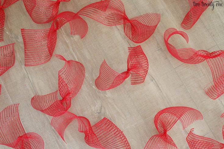 red sheer fabric with wavy lines on top and bottom, in the shape of hearts