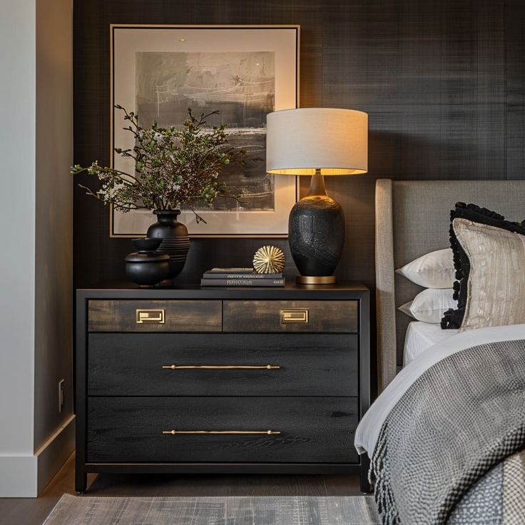 How to Style a Black Bedroom: Decor Ideas for a Bold Space Black Accent Room Bedroom, Bedroom Dressers As Nightstands, Bedroom Mirror Behind Nightstand, Black Nightstand Decor Ideas, Bedroom With Black Furniture Aesthetic, Black Furniture Decor Ideas, Grey Bed Styling Ideas, Black Accent Bedroom Decor, Black Nightstand Styling