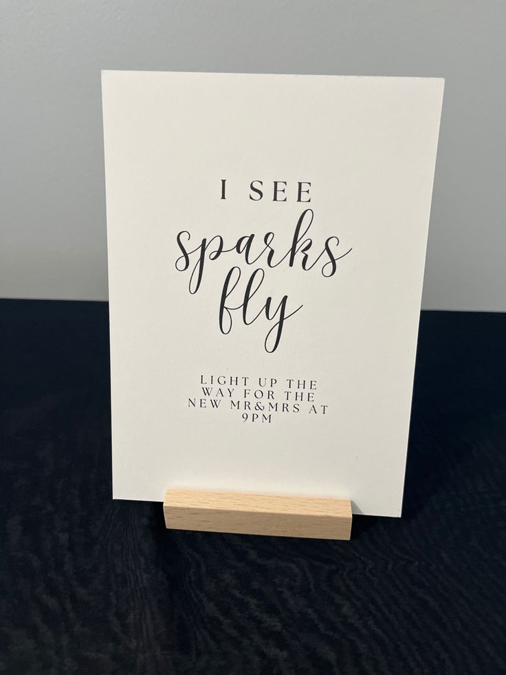 a card with the words i see sparks fly on it, sitting on top of a table