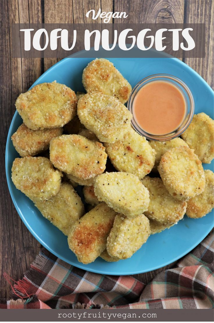 fried tofu nuggets on a blue plate with dipping sauce in the middle